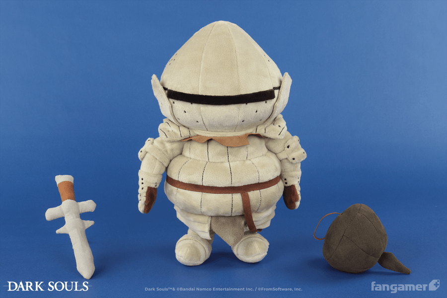 The official Siegmeyer plush photographed against a blue background. It's standing next to its plush sword and shield accessories, which are resting on the ground.  - Siegmeyer Plush - DARK SOULS