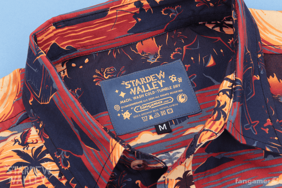 The tag for the shirt, showing the Stardew Valley logo as well as care instructions—machine wash cold, tumble dry.  - Ginger Island Resort Button Up Shirt - Stardew Valley