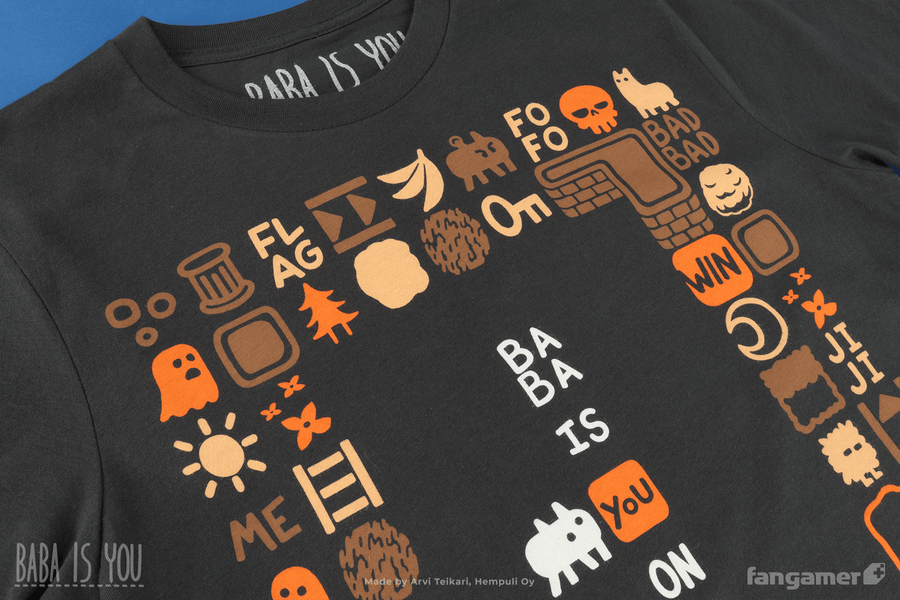 A closeup of the Baba Is Shirt t-shirt focusing on the top of the design; the frame of tiles surrounding Baba includes words like FLAG, ME, FOFO, and BADBAD as well as characters like a ghost and items like a key and ladder.  - Baba Is Shirt - Baba Is You