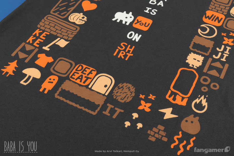 A closeup of the bottom of the Baba Is Shirt t-shirt. Here the frame features words like WIN, KEKE, and DEFEAT as well as several characters and items like a jack-o-lantern and a door.  - Baba Is Shirt - Baba Is You